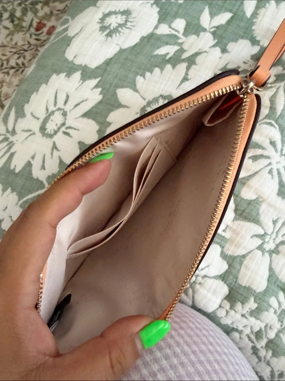 kate spade peach/orange leather wristlet with gold logo